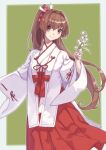  1girl alternate_costume border brown_hair cherry_blossoms commentary_request commission cowboy_shot flower green_background hakama japanese_clothes kantai_collection long_hair looking_at_viewer miko mitsuyo_(mituyo324) ponytail red_eyes red_hakama solo two-tone_background white_border yamato_(kancolle) 