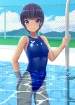  1girl black_hair blue_eyes blue_sky blue_swimsuit breasts chain-link_fence clouds commentary_request competition_swimsuit cowboy_shot day fence highleg highleg_swimsuit highres looking_at_viewer mountain one-piece_swimsuit original outdoors pool_ladder short_hair sky small_breasts smile solo swimsuit water yonesuke_(yonesukesuke) 