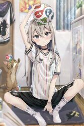  1girl animal arm_up ball between_legs black_hair black_shorts blue_nails blush calendar_(object) cat closed_mouth commentary_request curtains door grey_eyes grey_hair hair_between_eyes hand_between_own_legs head_tilt indoors jacket long_hair maruma_(maruma_gic) multicolored_hair nail_polish no_shoes original shirt shorts socks solo star_(symbol) streaked_hair striped_clothes striped_shirt unworn_jacket vertical-striped_clothes vertical-striped_shirt very_long_hair white_jacket white_shirt white_socks wooden_floor 