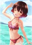  1girl bare_arms bare_shoulders bikini blush brown_eyes brown_hair collarbone cowboy_shot day groin hair_between_eyes highres kantai_collection mutsuki_(kancolle) navel ocean one_eye_closed ootori_(kyoya-ohtori) open_mouth red_bikini short_hair smile solo swimsuit twitter_username 