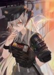  1girl ak_(ak98110881) arknights arm_behind_back bangs black_headwear cigarette collared_shirt commentary dragon_horns eyebrows_visible_through_hair grey_shirt hair_between_eyes hair_over_eyes hand_up hat highres holding holding_cigarette horns id_card indoors looking_at_viewer official_alternate_costume orange_eyes plate_carrier police_hat saria_(arknights) saria_(the_law)_(arknights) shirt silver_hair sleeves_rolled_up smoke smoking solo upper_body 