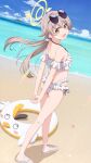  1girl arms_behind_back beach blue_archive blush commentary_request full_body halo hifumi_(blue_archive) highres ishida_seito light_brown_hair long_hair looking_at_viewer looking_back low_twintails ocean open_mouth peroro_(blue_archive) sky solo sunglasses swimsuit twintails yellow_eyes 