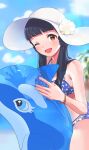  1girl absurdres bangs bare_shoulders beach bikini black_hair blue_bikini blue_hair blurry blurry_background blush breasts brown_eyes day dolphin flower hat highres idolmaster idolmaster_million_live! idolmaster_million_live!_theater_days inflatable_dolphin inflatable_orca inflatable_toy inuyama_nanami jewelry kitakami_reika long_hair looking_at_viewer medium_breasts necklace one_eye_closed open_mouth outdoors smile solo star_(symbol) star_necklace swimsuit twintails white_headwear wristband yellow_flower 