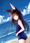  1girl alternate_costume animal_ears azur_lane bangs beach black_hair blue_sky blue_swimsuit blunt_bangs blurry breasts clouds cloudy_sky commentary_request contemporary depth_of_field eyebrows_visible_through_hair fox_ears from_behind horizon long_hair looking_at_viewer looking_back m_ko_(maxft2) nagato_(azur_lane) ocean old_school_swimsuit parted_lips school_swimsuit sidelocks sky small_breasts solo swimsuit twisted_torso yellow_eyes 
