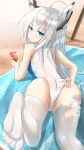  1girl absurdres adjusting_clothes adjusting_swimsuit animal_ears ass azur_lane bare_shoulders beach beach_towel blue_eyes cien_(shikanokuni) competition_swimsuit crazy_straw cup drinking_glass drinking_straw from_behind highres kawakaze_(azur_lane) long_hair looking_at_viewer one-piece_swimsuit solo swimsuit thigh-highs towel white_hair white_legwear white_swimsuit 