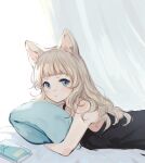  1girl animal_ears bangs bare_arms black_camisole blue_eyes book camisole cat_ears closed_mouth commentary_request curtains highres ikoan light_brown_hair long_hair looking_at_viewer lying on_bed on_stomach original pillow pillow_hug solo upper_body white_background 