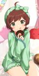  1girl :q ahoge blush bow brown_hair chocolate_doughnut doughnut eyebrows_visible_through_hair food green_bow green_eyes green_hairband green_shirt green_shorts hair_bow hairband heart heart_print highres holding holding_food idolmaster idolmaster_million_live! idolmaster_million_live!_theater_days inuyama_nanami kinoshita_hinata long_sleeves looking_at_viewer on_bed pajamas shirt shorts sitting smile solo tongue tongue_out 