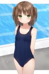  1girl anz32 arms_behind_back bangs bare_arms bare_shoulders blue_swimsuit blurry blurry_background blush breasts brown_hair closed_mouth collarbone commentary_request covered_navel cowboy_shot depth_of_field eyebrows_visible_through_hair green_eyes one-piece_swimsuit original school_swimsuit small_breasts solo swimsuit twitter_username two_side_up 
