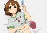  1girl bangs brown_eyes brown_hair commentary_request food from_above grey_shirt hand_fan hand_on_own_stomach hand_up heart highres hirasawa_yui holding holding_food k-on! kicchi_(tmgk) looking_at_viewer lying midriff_peek on_back on_bed parted_lips popsicle shirt short_hair short_sleeves shorts solo t-shirt teeth translated upper_body white_shorts 