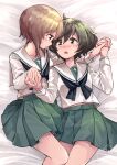  2girls ahoge aioi_aoi akiyama_yukari bangs black_neckwear blouse blush brown_eyes brown_hair eyebrows_visible_through_hair girls_und_panzer green_skirt highres holding_hands long_sleeves lying messy_hair multiple_girls neckerchief nishizumi_miho on_back on_bed ooarai_school_uniform pleated_skirt sailor_collar school_uniform serafuku short_hair skirt white_blouse white_sailor_collar yuri 