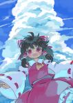  1girl :d ascot bangs black_hair blue_sky bow clouds cowboy_shot detached_sleeves eyebrows_visible_through_hair frilled_skirt frills from_below hair_bow hair_tubes hakurei_reimu highres kibisake looking_at_viewer medium_hair open_mouth outdoors red_bow red_eyes red_shirt red_skirt ribbon-trimmed_sleeves ribbon_trim shirt skirt sky smile solo standing touhou wide_sleeves yellow_neckwear 