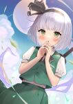  1girl bangs black_bow black_hairband black_neckwear blue_sky bow bowtie clouds cowboy_shot dutch_angle goma_(u_p) green_eyes green_skirt green_vest hairband hands_together konpaku_youmu konpaku_youmu_(ghost) looking_at_viewer open_mouth outdoors puffy_short_sleeves puffy_sleeves shirt short_hair short_sleeves silver_hair skirt sky solo standing vest white_shirt 