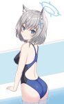  1girl animal_ear_fluff animal_ears ass bangs blue_archive blue_eyes competition_swimsuit cross_hair_ornament from_behind grey_hair hair_ornament halo mun_(gunma) one-piece_swimsuit poolside shiroko_(blue_archive) short_hair soaking_feet solo swimsuit water 