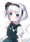  1girl bangs black_bow black_hairband black_neckwear blue_eyes blush bow bowtie buttons closed_mouth collar eyebrows_visible_through_hair eyes_visible_through_hair ghost green_skirt green_vest hairband hand_up highres konpaku_youmu konpaku_youmu_(ghost) looking_at_viewer myon_(phrase) puffy_short_sleeves puffy_sleeves shirt short_sleeves short_twintails silver_hair simple_background skirt solo suzuno_naru touhou twintails vest white_background white_collar white_shirt white_sleeves 