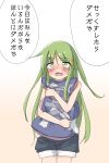  1girl alternate_costume beige_background blush commentary_request cowboy_shot crescent crescent_hair_ornament denim denim_shorts gradient gradient_background green_eyes green_hair hair_ornament highres kantai_collection long_hair looking_at_viewer mother_and_child nagatsuki_(kancolle) nose_blush open_mouth pillow pillow_hug po0000000000 shorts solo translation_request upper_teeth white_background 