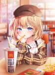  1girl bangs blonde_hair blurry blurry_background blush brown_headwear cup disposable_cup eyebrows_behind_hair food food_in_mouth french_fries gawr_gura hair_ornament hand_on_own_face highres hololive hololive_english indoors looking_at_viewer mcdonald&#039;s meul monocle_hair_ornament short_hair sitting solo sticker watson_amelia 