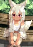  1girl absurdres animal_ear_fluff animal_ears bench blonde_hair crop_top dappled_sunlight dark-skinned_female dark_skin fox_ears fox_girl fox_tail hat highres holding holding_clothes holding_hat kotori_aoi looking_at_viewer navel off_shoulder original red_eyes sitting_on_bench smile straw_hat sunlight tail tank_top tree_shade white_tank_top 