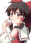  1girl bare_shoulders blush bow brown_eyes brown_hair closed_mouth detached_sleeves eating eyebrows_visible_through_hair food food_on_face hair_between_eyes hair_bow hair_tubes hakurei_reimu highres holding holding_food long_hair nontraditional_miko red_bow ribbon-trimmed_sleeves ribbon_trim sidelocks simple_background solo touhou white_background wide_sleeves yutamaro 