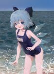 1girl :d alternate_costume arm_at_side bangs bare_arms bare_shoulders beach blue_bow blue_eyes blue_hair blue_nails blue_sky blue_swimsuit bow cirno collarbone crossed_bangs day eyebrows_visible_through_hair feet_out_of_frame from_side hair_between_eyes hair_bow half_updo hand_up highres horizon leaning_forward light_blush looking_at_viewer looking_to_the_side nail_polish name_tag no_lineart ocean old_school_swimsuit one-piece_swimsuit open_mouth outdoors reddizen school_swimsuit short_hair sky smile solo splashing standing swimsuit touhou water water_drop wavy_hair wings 