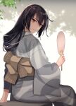  1girl black_hair closed_mouth eyebrows_visible_through_hair hair_between_eyes hand_fan highres holding holding_fan japanese_clothes kantai_collection kasumi_(skchkko) kimono long_hair long_sleeves nagato_(kancolle) obi paper_fan red_eyes sash smile solo uchiwa wide_sleeves yukata 