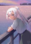  1girl blue_eyes blue_flower character_name closed_mouth flower from_side green_skirt grey_hair hair_flower hair_ornament happy_tears highres horizon indie_virtual_youtuber leaning_forward long_hair looking_at_viewer looking_to_the_side lyrica_(vtuber) ocean outdoors ponytail railing shirt short_sleeves sidelocks signature skirt smile solo tears temachii white_shirt 