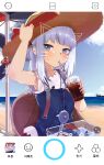  1girl absurdres bag beach bloop_(gawr_gura) blue_dress blue_eyes blush clouds cola cup drawn_ears drawn_whiskers dress drinking drinking_straw_in_mouth face_filter fish_tank gawr_gura hair_ornament hairclip hat hat_ribbon highres holding holding_cup hololive hololive_english horizon knbd long_hair looking_at_viewer ocean official_alternate_costume outdoors phone_screen red_ribbon ribbon shirt shoulder_bag silver_hair sitting sky sleeveless sleeveless_shirt soda solo_focus straw_hat summer suspenders sweatdrop virtual_youtuber white_shirt 
