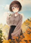  1girl absurdres black_skirt blush breasts brown_hair brown_sweater clouds collarbone cup disposable_cup highres holding holding_cup kazanock long_skirt long_sleeves medium_breasts orange_flowers original outdoors pout red_eyes skirt sky sleeves_past_wrists solo sweater 