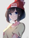  1girl bangs beanie blue_eyes brown_hair collarbone eyebrows_visible_through_hair eyelashes floral_print grey_background hat highres parted_lips pokemon pokemon_(game) pokemon_sm red_headwear selene_(pokemon) shirt short_hair short_sleeves signature solo t-shirt tere_asahi upper_body yellow_shirt 