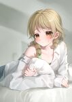  1girl absurdres bed_sheet blonde_hair blush borrowed_garments commentary_request embarrassed eyebrows_visible_through_hair frown highres idolmaster idolmaster_cinderella_girls looking_at_viewer lying morikubo_nono ningen_mame object_hug on_stomach oversized_clothes oversized_shirt pillow pillow_hug ringlets shirt shirt_slip single_bare_shoulder sleeves_past_wrists solo sweatdrop white_shirt 