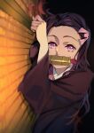  1girl absurdres bit_gag black_hair blurry blurry_foreground brown_hair from_side gag hair_ribbon highres ibaraki_shun kamado_nezuko kimetsu_no_yaiba long_hair long_sleeves looking_at_viewer lying multicolored_hair on_side pink_eyes pink_ribbon ribbon solo two-tone_hair upper_body 