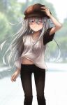  1girl black_pants blue_eyes blush brown_headwear closed_mouth commentary_request eyebrows_visible_through_hair glasses hair_between_eyes hand_on_headwear hat hibiki_(kancolle) highres jewelry kantai_collection kuuru_(kuuru-n) long_hair navel pants ring shirt silver_hair smile solo t-shirt white_shirt 