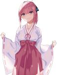  1girl alternate_hairstyle bangs blue_eyes blunt_bangs breasts closed_mouth collarbone eyebrows_visible_through_hair go-toubun_no_hanayome hair_ribbon hakama hands_up highres japanese_clothes long_sleeves miko nakano_nino pink_hair red_hakama ribbon simple_background smile solo susukida_(sususabu0710) wide_sleeves 