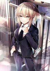  1girl bangs belt belt_buckle black_suit blonde_hair blush breasts buckle fate/grand_order fate_(series) formal gate hand_in_pocket hane_yuki highres katana koha-ace long_sleeves looking_at_viewer medium_breasts necktie okita_souji_(fate) okita_souji_(koha/ace) rain short_hair short_ponytail smile suit sword weapon yellow_eyes 