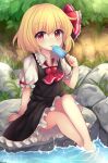  1girl :q ahoge ascot bangs black_dress blonde_hair blush bow commentary_request day dot_nose dress eyebrows_visible_through_hair eyelashes fingernails flat_chest food frilled_dress frilled_shirt_collar frills grass highres licking long_sleeves looking_at_viewer outdoors popsicle puffy_short_sleeves puffy_sleeves red_bow red_eyes red_neckwear red_ribbon ribbon rock ruhika rumia shiny shiny_hair shirt short_hair short_sleeves sitting_on_rock solo thighs tongue tongue_out touhou upper_body water white_shirt 