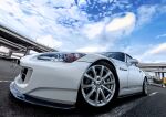  3books absurdres bridge car clouds ground_vehicle headlight highres honda honda_s2000 license_plate motor_vehicle no_humans original photorealistic scenery sky solo vehicle_focus 