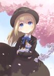  1girl animal black_dress blonde_hair blue_eyes bow bowtie branch cat cherry_blossoms closed_mouth crossed_arms dress hat highres holding holding_animal holding_cat long_hair long_sleeves moe2020 original petals smile solo split_mouth suezu1022 
