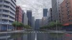  artist_name building city cityscape clouds cloudy_sky commentary_request crosswalk dankalaning english_text highres lamppost no_humans original plant reflection reflective_water road scenery sky tree 