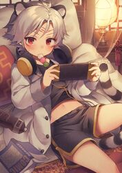  1boy animal_ears bed book bottle child commentary eating eyebrows_visible_through_hair headphones looking_at_viewer male_focus midriff_peek navel nintendo_switch original playing_games red_eyes shorts solo utsunomiya_hetaru water_bottle white_hair 