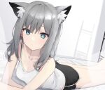 1girl animal_ear_fluff animal_ears arm_support bangs bare_shoulders bed black_shorts blue_archive bra_strap breasts camisole closed_mouth dolphin_shorts dot_nose feet_out_of_frame green_eyes grey_hair highres korean_commentary long_hair looking_at_viewer lying mismatched_pupils on_bed on_stomach shiroko_(blue_archive) shirt short_shorts shorts sidelocks small_breasts solo syhan white_shirt 