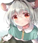  1girl animal_ear_fluff animal_ears ashino_chimado blue_capelet blurry blush capelet depth_of_field eyebrows_visible_through_hair from_above gold_trim hair_between_eyes light_smile mouse_ears nazrin red_eyes silver_hair simple_background solo touhou white_background 