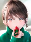 1girl bangs blurry blurry_background brown_hair eating food fruit green_sweater hand_up highres holding holding_food long_hair long_sleeves looking_at_viewer ojay_tkym original pink_eyes solo strawberry sweater turtleneck turtleneck_sweater 