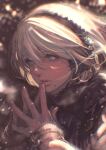  1girl alternate_costume bangs blue_eyes blurry blurry_background bob_cut breath cold commentary earmuffs eyelashes hair_between_eyes hairband highres kazama_raita lips long_sleeves looking_away mole mole_under_mouth motion_blur nier_(series) nier_automata own_hands_together portrait short_hair snow snowing solo steepled_fingers symbol-only_commentary symbol-shaped_pupils white_hair wind yorha_no._2_type_b 