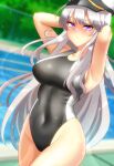  1girl azur_lane black_swimsuit blurry blurry_background breasts competition_swimsuit cowboy_shot dutch_angle enterprise_(azur_lane) fence hat kaguya-san_(nantyu-erosada) large_breasts long_hair one-piece_swimsuit peaked_cap pool silver_hair solo swimsuit very_long_hair violet_eyes white_headwear 