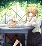  1girl ahoge artoria_pendragon_(fate) bangs black_ribbon black_skirt blonde_hair braid breasts cake collared_shirt commentary creature cup dated english_commentary eyebrows_visible_through_hair fate/grand_order fate_(series) feet_out_of_frame food fou_(fate) french_braid green_eyes hair_bun hair_ribbon highres kuroaki long_skirt looking_at_viewer medium_breasts medium_hair necktie outdoors parted_lips plant plate red_necktie ribbon saber shirt signature sitting skirt sleeveless solo table tea teapot violet_eyes white_shirt wristband 