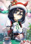  1girl bangs bell black_hair blue_eyes blurry blurry_background blurry_foreground blush bow bowtie chair commentary_request cup detached_sleeves dirndl eishin_flash_(umamusume) food fork german_clothes green_bow green_bowtie holding holding_fork holding_plate horse_girl indoors looking_at_viewer plant plate saucer signature sitting solo strawberry_shortcake teacup tinsel umamusume utensil_in_mouth yamahara 
