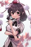  1girl 5alive arm_under_breasts black_hair blurry breasts depth_of_field hat holding holding_pen leaf looking_at_viewer maple_leaf medium_breasts medium_hair pen pointy_ears pom_pom_(clothes) red_eyes shameimaru_aya simple_background smile solo tokin_hat touhou white_background 