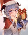  1girl bangs bell black_gloves blue_hair blush bow breasts capelet christmas commentary detached_sleeves eyebrows_visible_through_hair ganyu_(genshin_impact) genshin_impact gift gloves gold_trim hat highres holding holding_gift horns long_hair looking_at_viewer merry_christmas neck_bell red_capelet santa_hat sidelocks smile solo upper_body ura_illust violet_eyes white_sleeves 