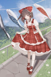 1girl absurdres black_eyes black_hair block_heels bow closed_mouth clothes_lift clouds collared_shirt commentary_request day dress dress_lift flower frilled_bow frilled_hair_tubes frilled_shirt_collar frilled_sleeves frills full_body grass hair_bow hair_tubes hakurei_reimu highres looking_down nanaku outdoors plaid_bow plaid_clothes plaid_dress puffy_short_sleeves puffy_sleeves railing red_bow red_dress red_shoes shadow shirt shoes short_hair short_sleeves socks solo standing touhou white_flower white_shirt white_socks 
