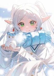  1girl absurdres blue_scarf blurry blurry_foreground breath closed_mouth coat commentary_request depth_of_field earrings elf floating_hair flower flower_wreath frieren gem green_eyes highres holding holding_snowman jewelry long_hair parted_bangs pointy_ears scarf short_eyebrows smile snowman solo sousou_no_frieren tujiu_sama twintails white_coat white_hair 