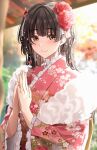  1girl amyu_(amm_asl_pa) black_hair blurry blurry_background blush depth_of_field eyebrows_visible_through_hair floral_print flower frilled_kimono frills fur-trimmed_kimono fur_trim furisode hair_flower hair_ornament highres idolmaster idolmaster_shiny_colors japanese_clothes kimono light_smile looking_at_viewer mayuzumi_fuyuko obi outdoors own_hands_together pink_kimono praying print_kimono sash solo two_side_up upper_body 